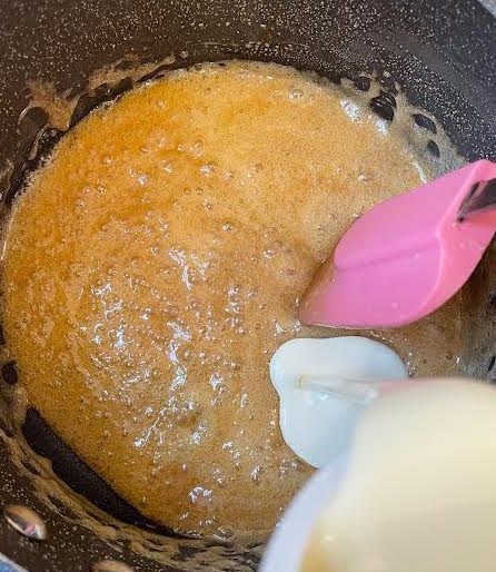 Cream being added to caramel