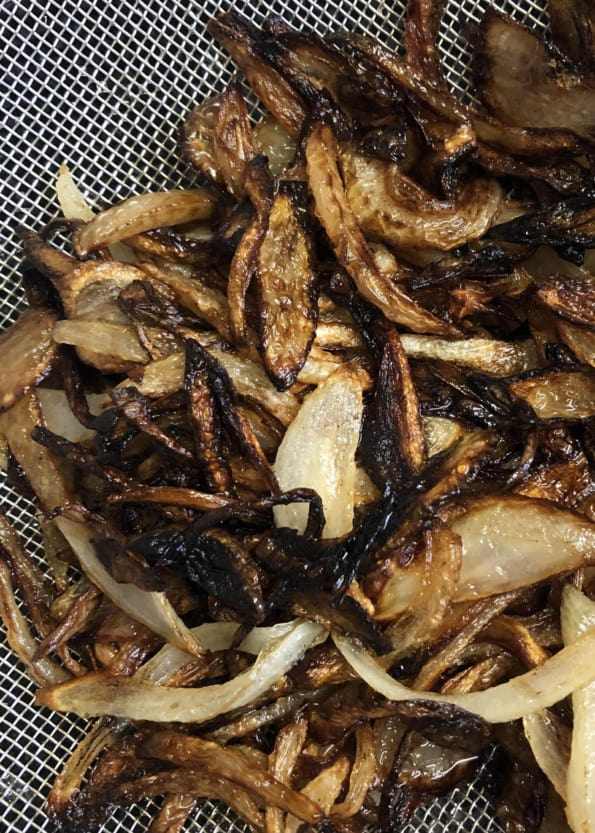 Fried onions in a fine mesh strainer