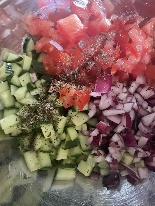 Cucumber, tomato and onion in bowl