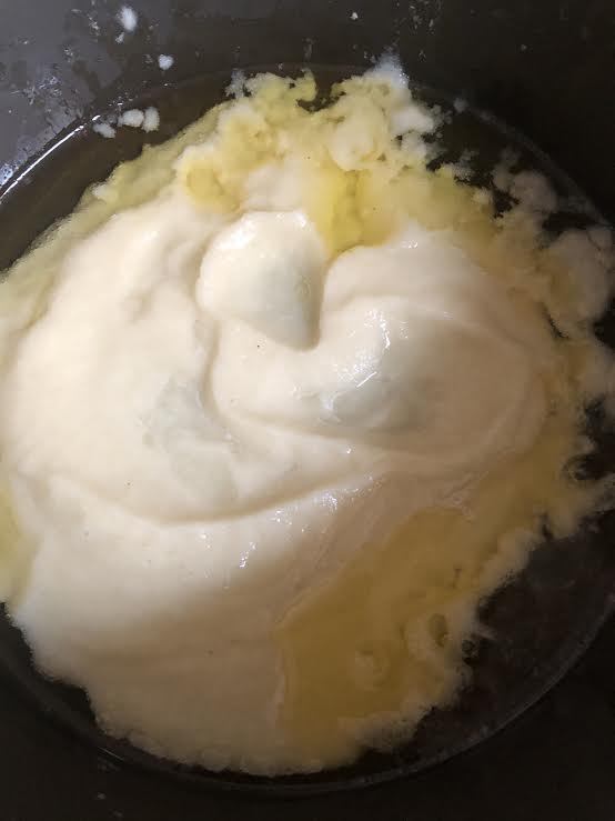 Onion paste in a pan with ghee and oil