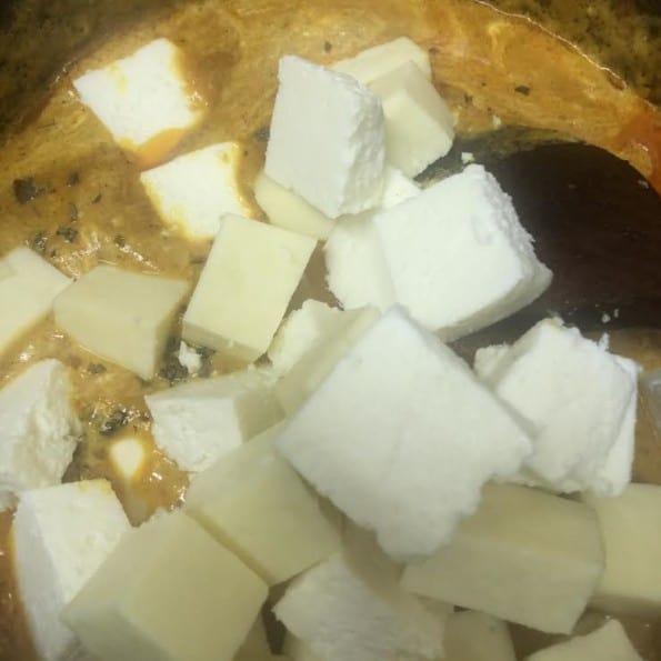 Cubed Paneer being added to pot
