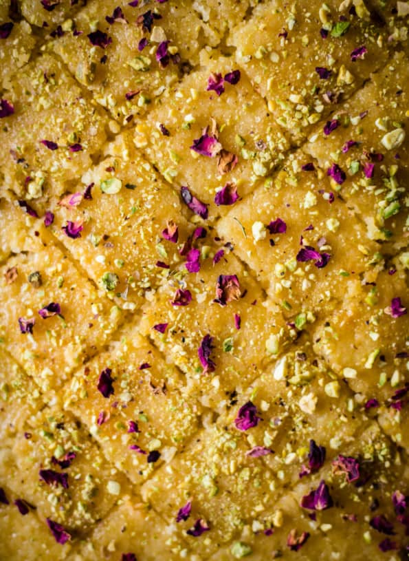 Baklava traybake cut into diamond shapes with pistachio and rose petals scattered on top