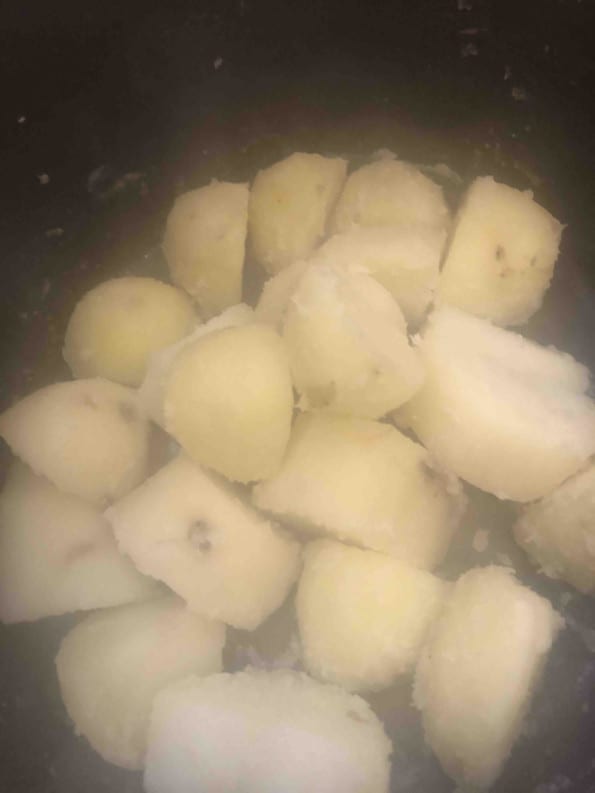 Potatoes steaming in pot