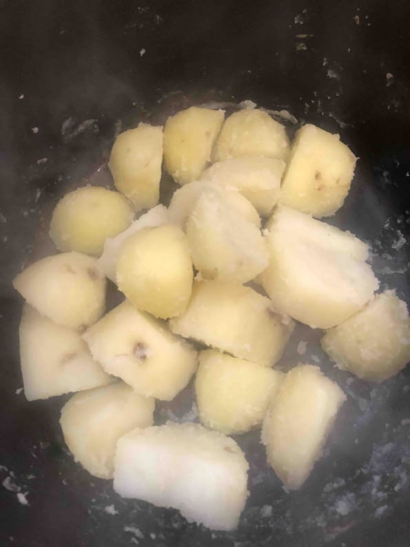 Potatoes with scraggly edges in pot