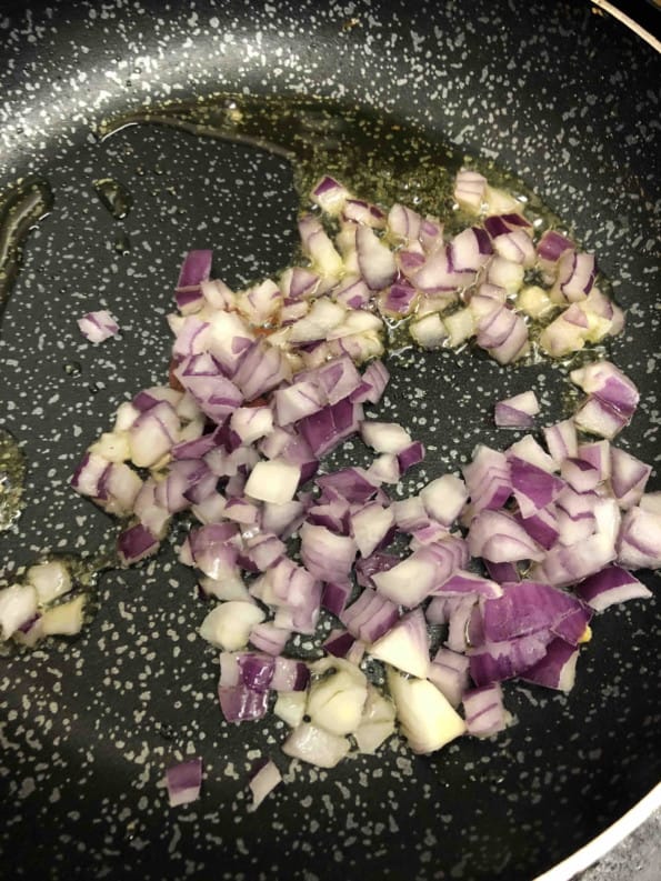 Onions cooking in oil in pan