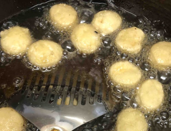Donuts being deep fried in oil