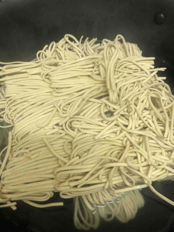 Noodles in boiling water in pot