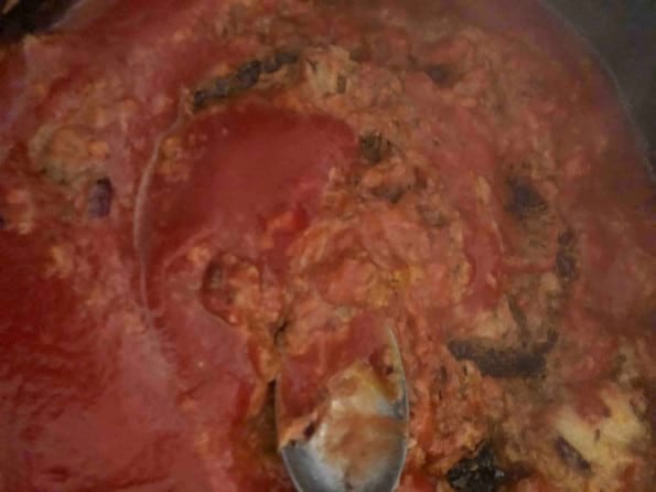 Pureed tomatoes added to pot