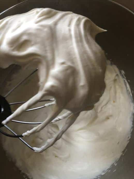 Whipped cream in bowl of stand mixer