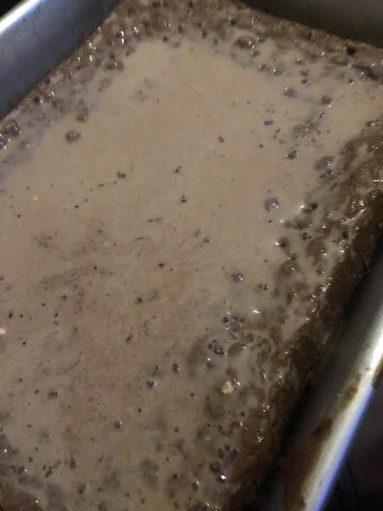 Chocolate syrup added to cake tin