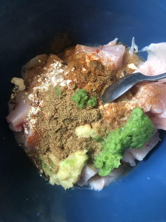 Chicken, Yoghurt and Spices in a bowl with spoon