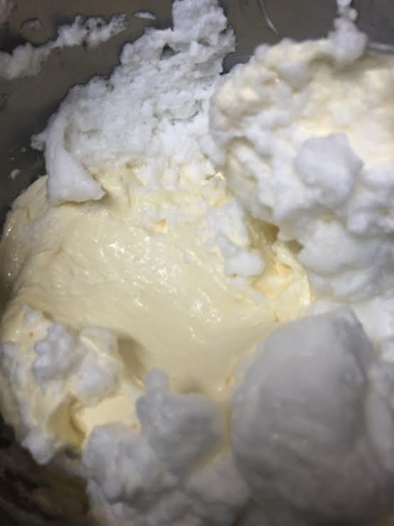 Egg whites being stirred into mascarpone