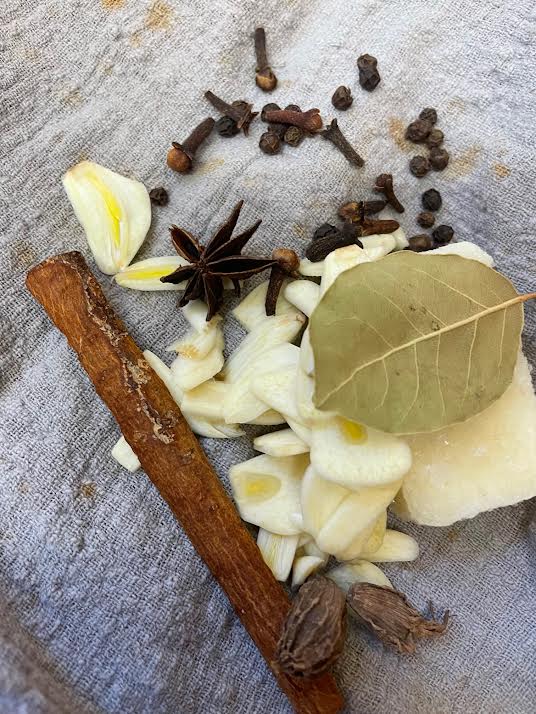 Garlic, Bay Leaves, Cloves, Star Anise and Cinnamon on a muslin cloth