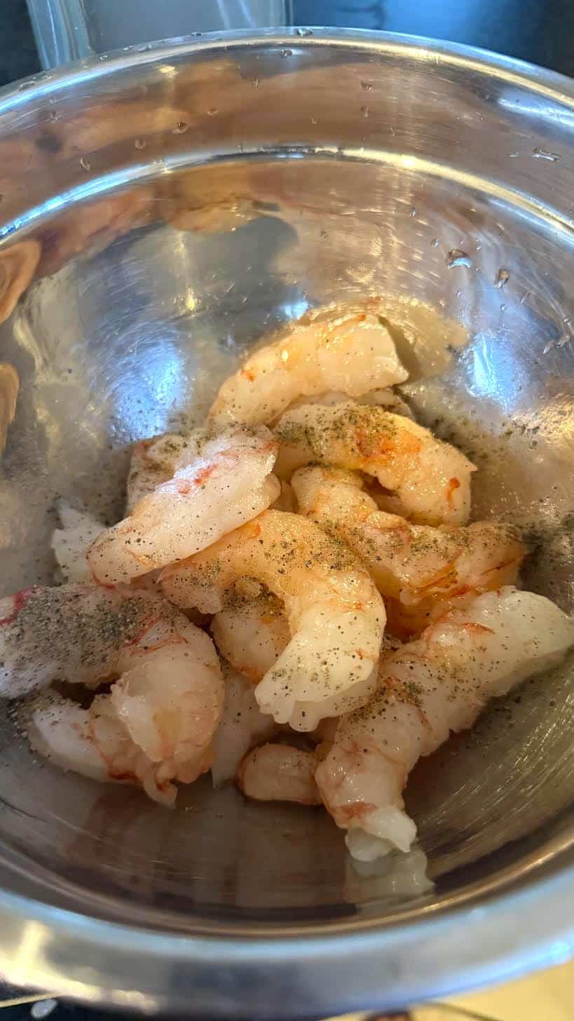 Spanish Gambas Pil Pil - Shrimp with Garlic Chilli Oil Prawns in bowl with seasoning