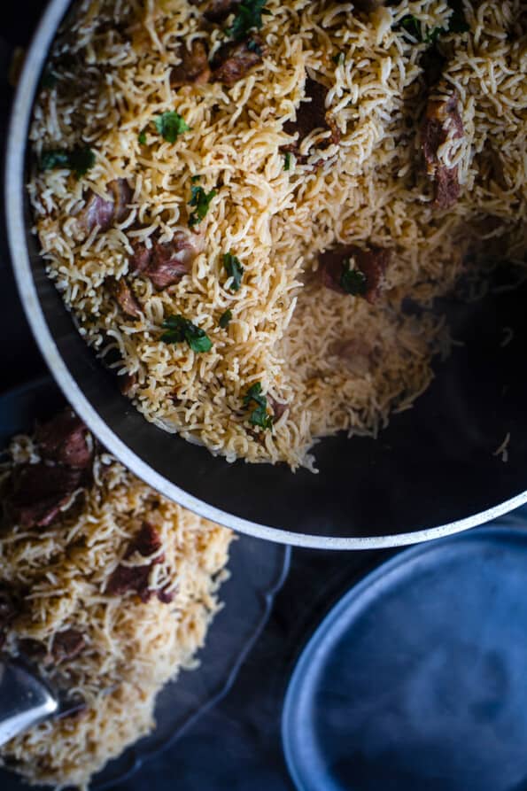 Mutton Pulao in pot with some taken out in serving dish