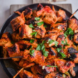 Tandoori Chicken Kebab skewers and pieces in a plate