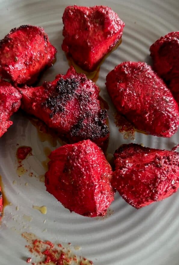 Tandoori Chicken Tikka Bites or Kebab Skewers Cooked chicken tikka pieces on plate