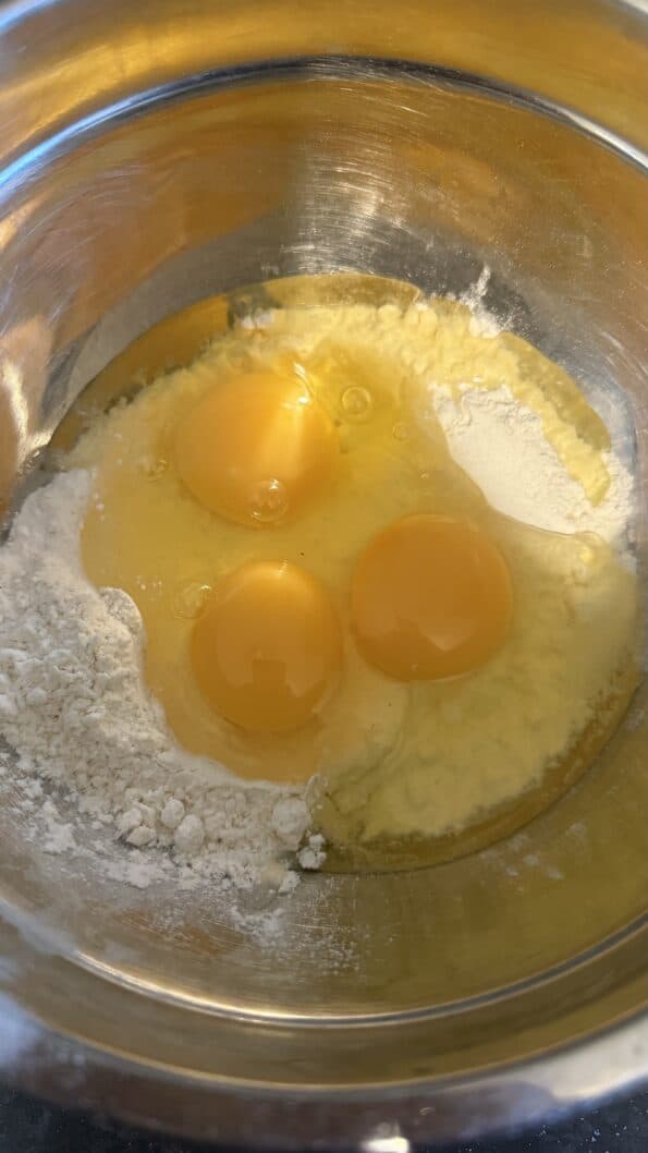 Crispy, fluffy Yorkshire puddings - (simple, fool proof and no fail) Eggs in bowl with flour