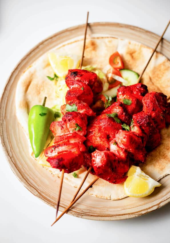 Tandoori Chicken Tikka Bites or Kebab Skewers Tandoori chicken skewers on Naan