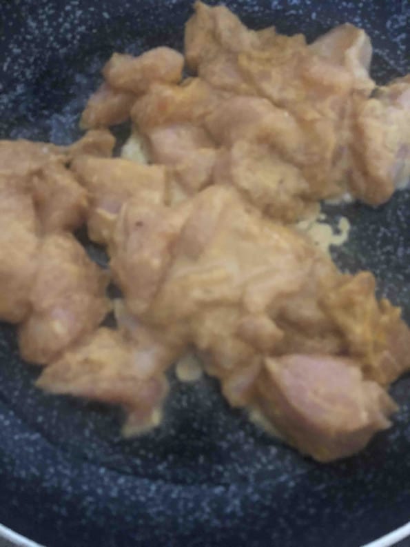 Marinaded Chicken in a pan with oil