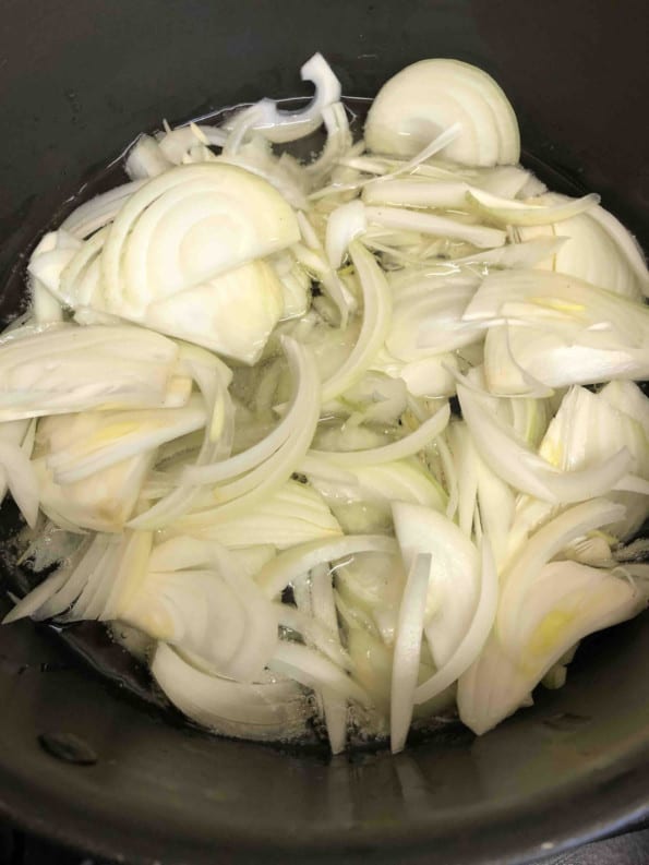 Sliced onions in pot
