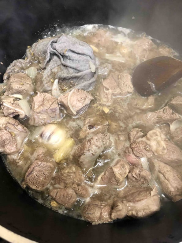 Boiled meat and spices in pot
