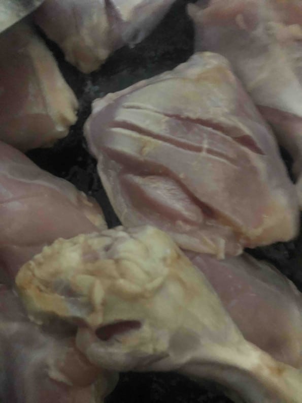 Slit Chicken in pot being cooked