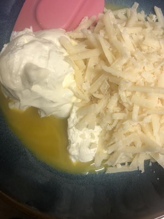 Egg Yolks, Lemon, Parmesan and Cream in a bowl being stirred