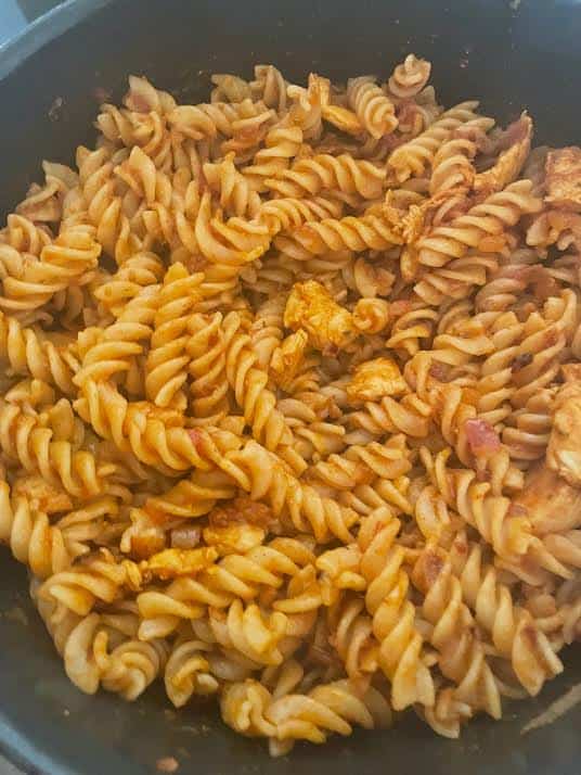 Cooked pasta in sauce in pot