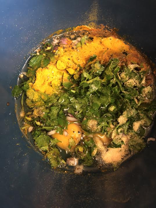 Eggs, spices and coriander in a bowl 