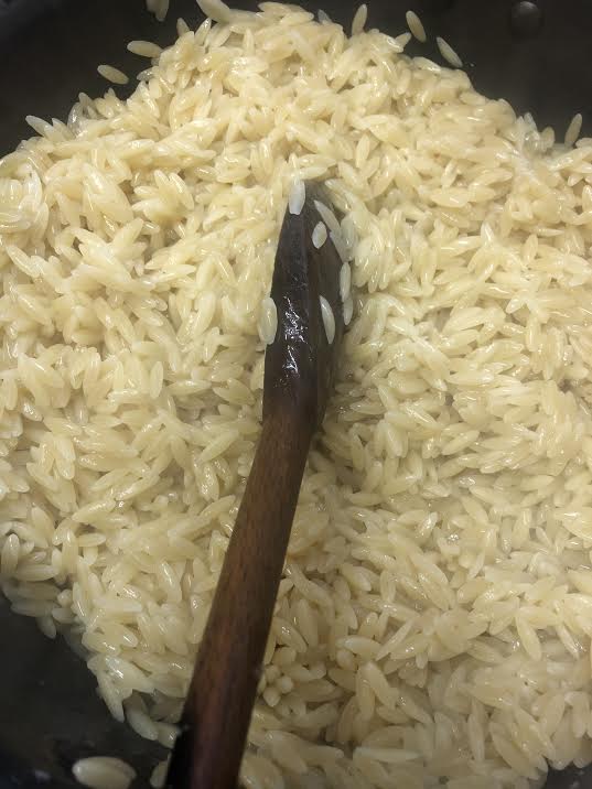 Orzo mixed with butter in pot