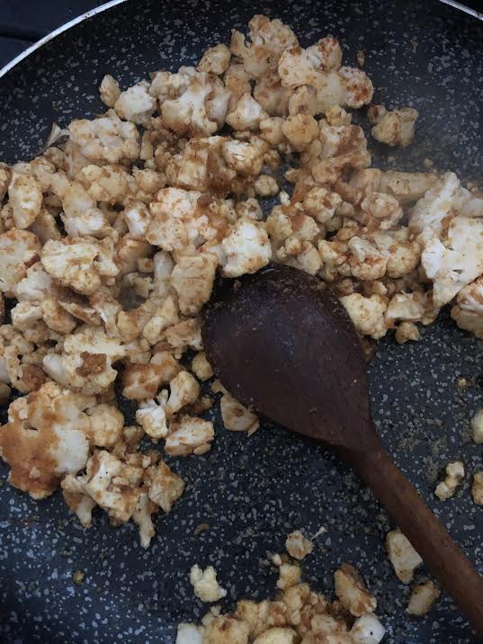 Cauliflower and spices cooking in a pan