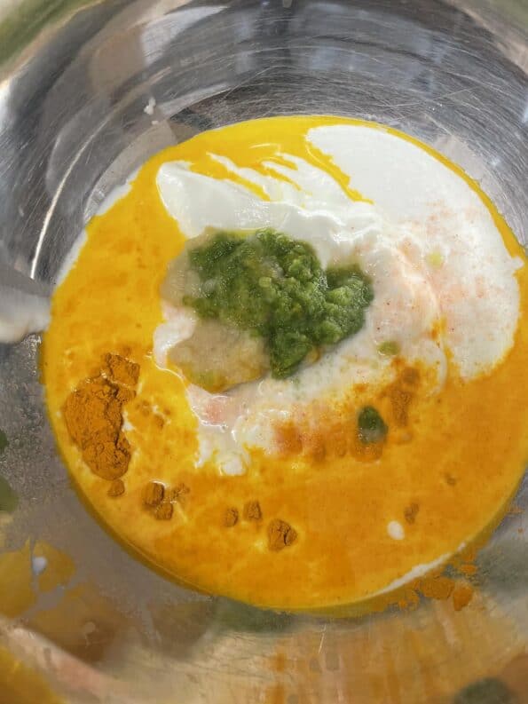 Green Chilli paste added to Yoghurt in bowl