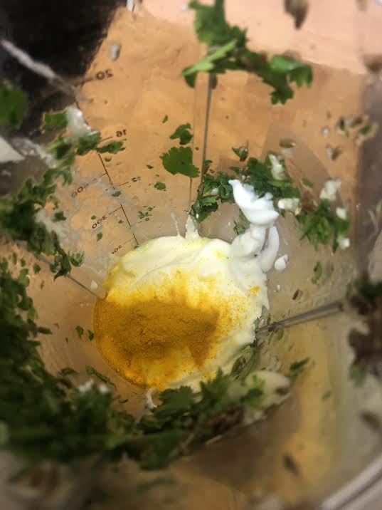 Yoghurt and Turmeric added to blender with coriander
