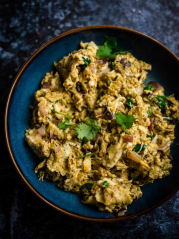 Egg Bhurji in a blue bowl topped with coriander