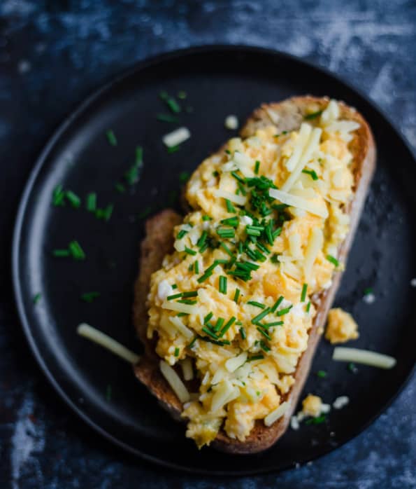 Scrambled Eggs with Cheese and chives on a piece of toast