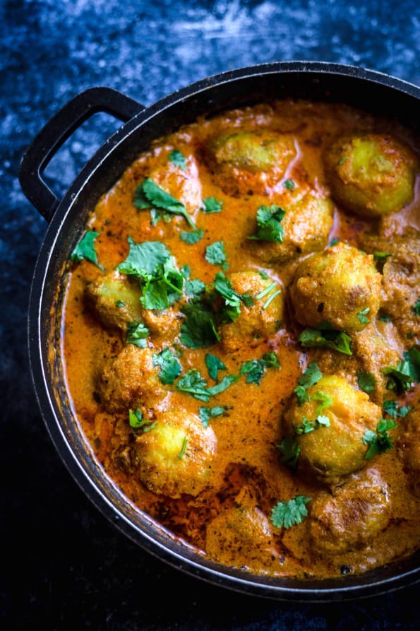 Dum Aloo in a pot wit coriander sprinkled on top