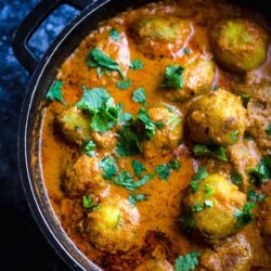 Dum Aloo in a pot wit coriander sprinkled on top