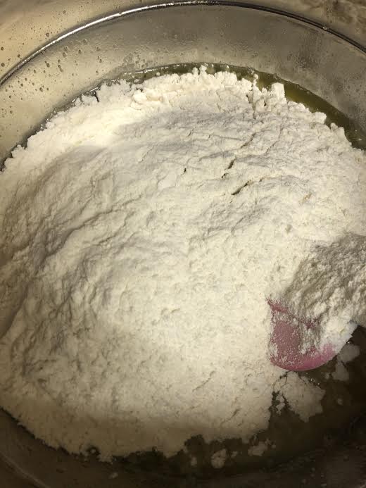 Flour being stirred into blondie batter