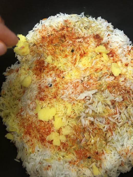 Ghee dotted all over the top of rice