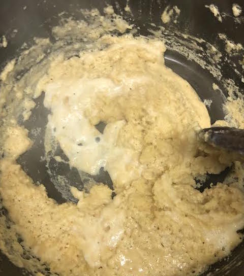 Thickened roux with a little milk being stirred in