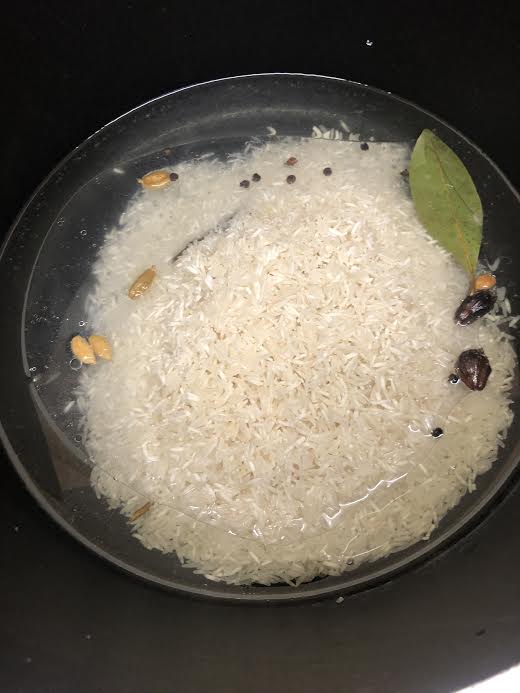 Rice added to water in pot