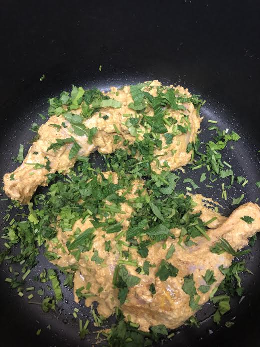 Chicken at bottom of pot with coriander on top