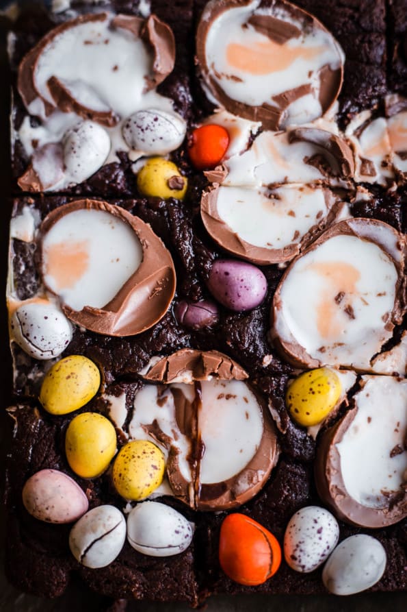 Creme Egg Brownies and mini eggs on top of brownies in a tin