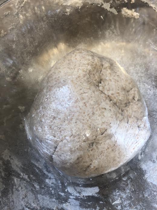 Dough wrapped in clingfilm in bowl