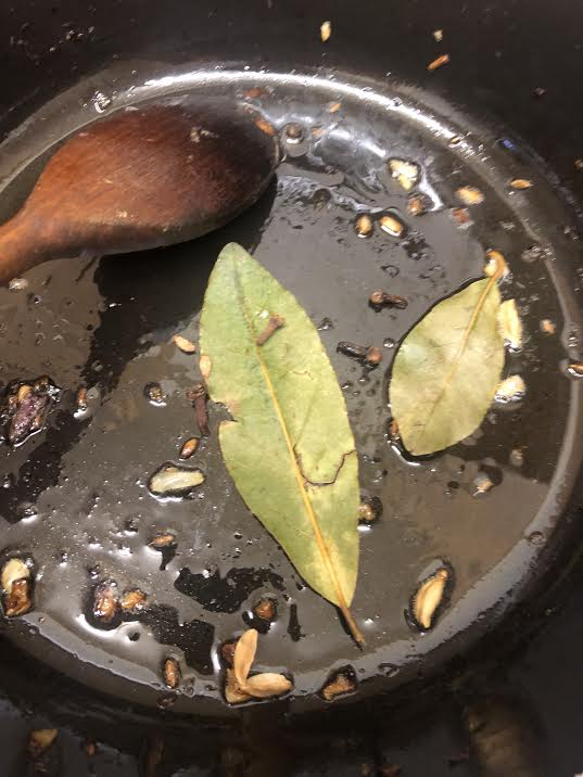 Whole spices frying on ghee in pot