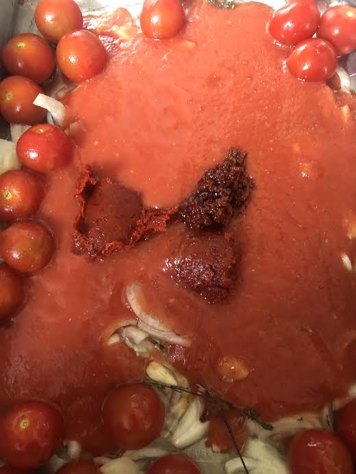 Pureed tomatoes and rose harissa added to tin