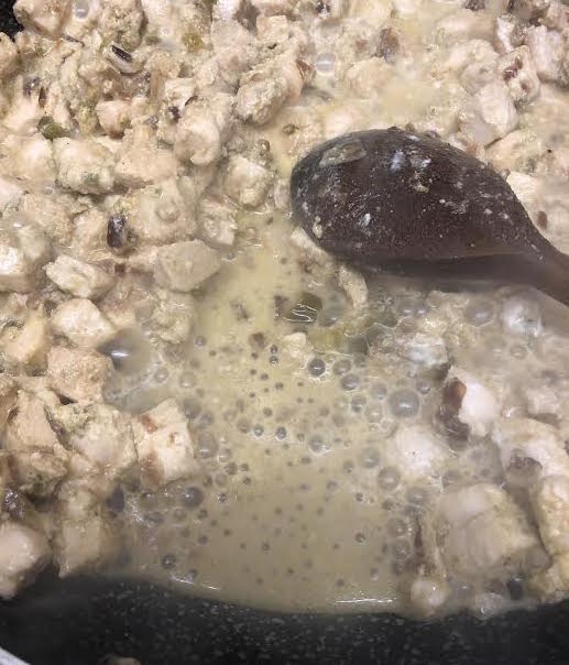 Chicken filling being cooked in pan on stove