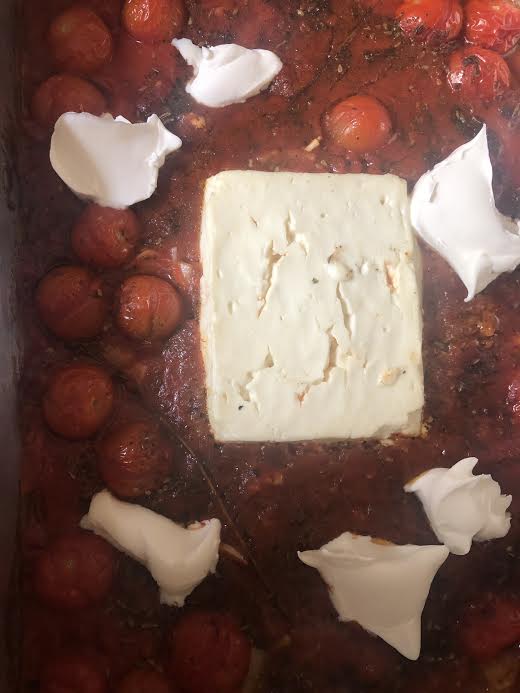Baked feta in tomatoes with mascarpone added to top