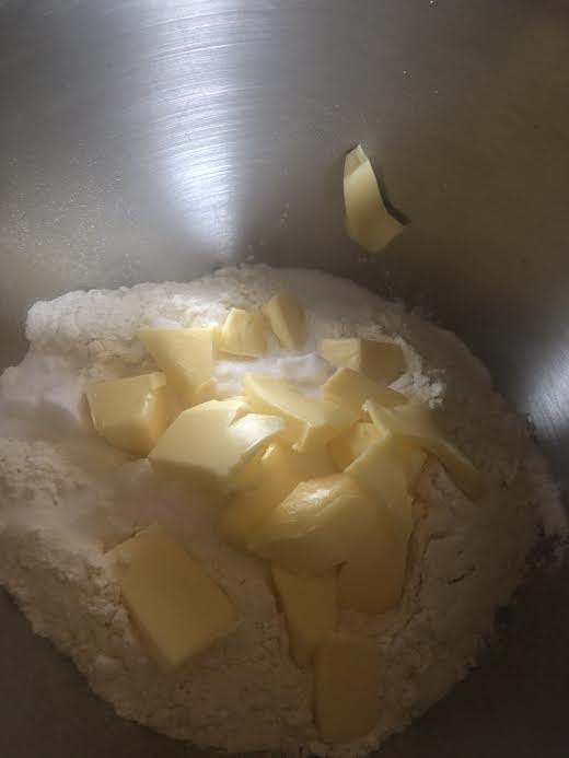 Butter added to dry ingredients in bowl